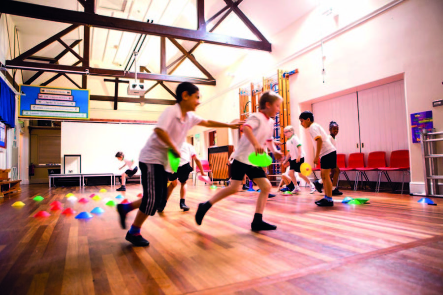 fiesta sports coaching school children playing in school hall